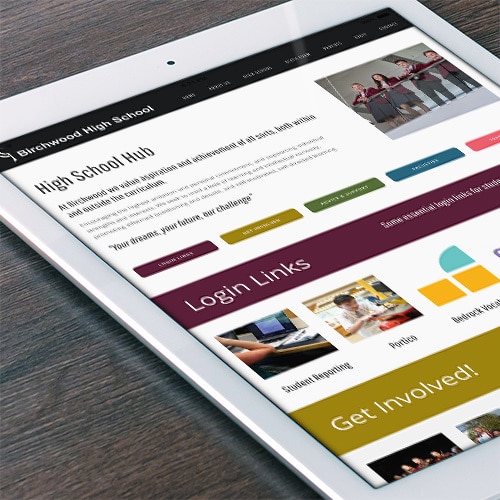 Tablet on a table displaying Birchwood High School responsive website