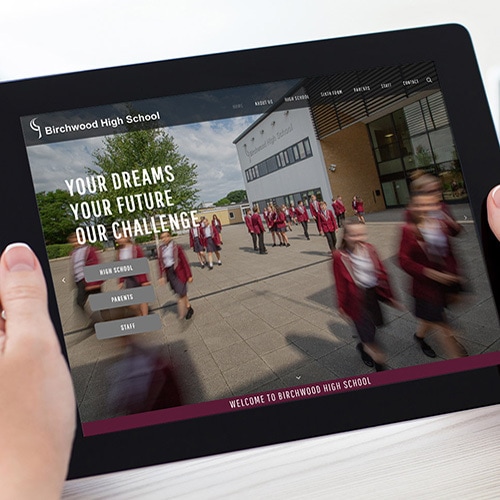 A person viewing Birchwood High School website on tablet thumbnail