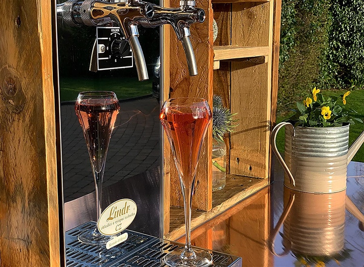 Close up of taps and glasses filled with Prosecco in Bubblicious branded Tuk Tuk