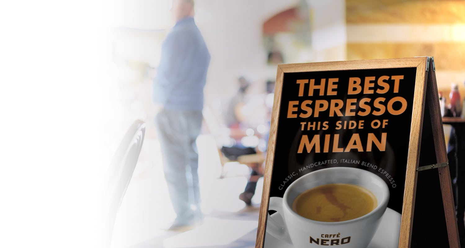 Signage with Caff&egrave; Nero promotion showing a digitally retouched map of Italy swirling in the froth of the Espresso in the cup