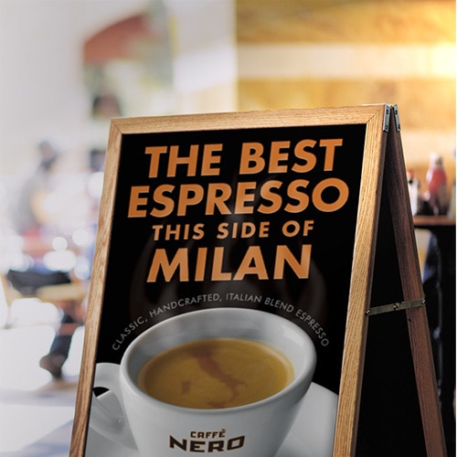 Signage with Caffè Nero promotion showing a digitally retouched map of Italy swirling in the froth of the Espresso in the cup