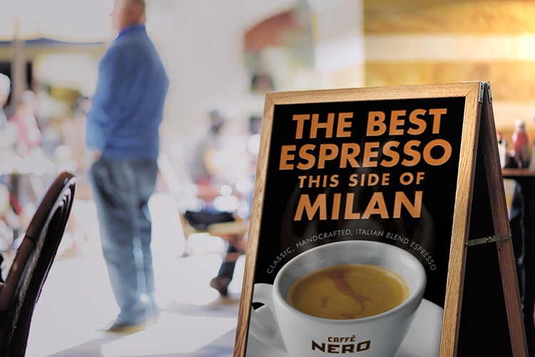 Signage with Caffè Nero promotion showing a digitally retouched map of Italy swirling in the froth of the Espresso in the cup