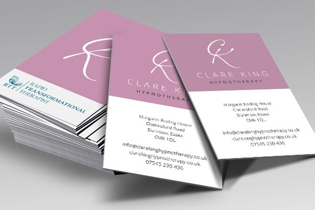 Business cards spread apart with Clare King branding