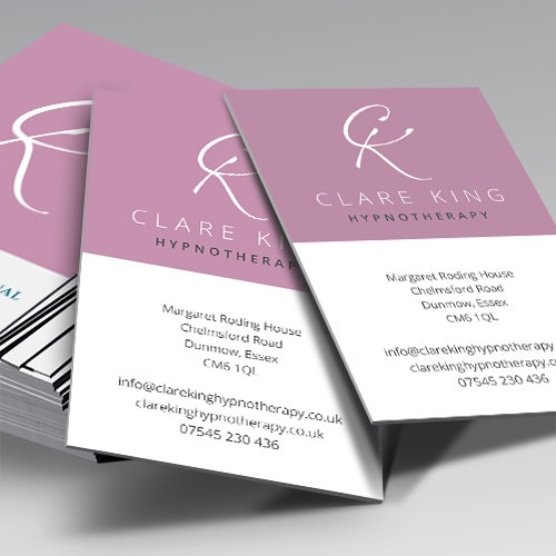 Business cards spread apart with Clare King branding