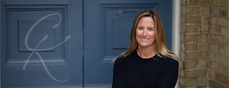 Woman in front of blue doors Facebook banner with Clare King logo