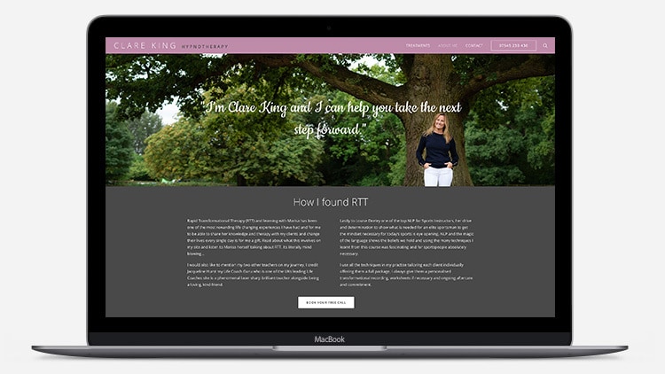 Laptop showing Clare King website design with image of woman under a tree