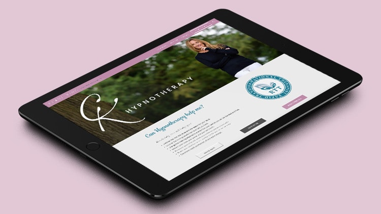 Tablet displaying Clare King responsive website design with image of woman under a tree