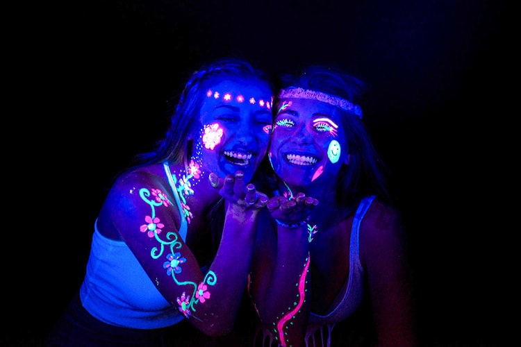 People with glowing face paint