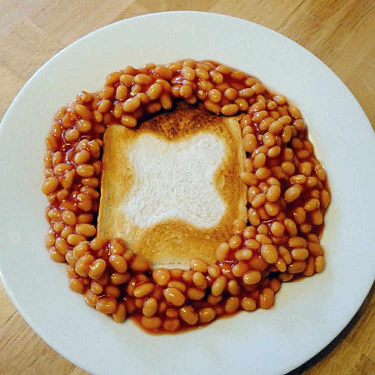 Beans on toast breakfast with GEO symbol on toasted bread slice