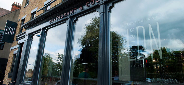 Exterior branding showing projecting sign and window decal of LDN Grill Logo design