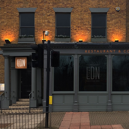 Front of Restaurant with copper signage and window decal with illuminated signage for LDN Grill branding Thumbnail