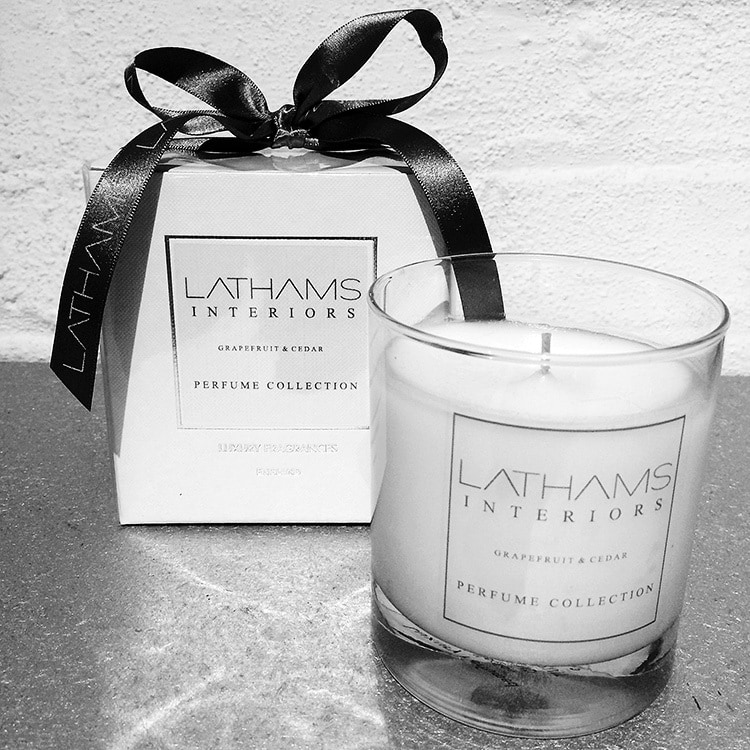 Close up of Lathams branded candle and candle box with a bow for Website