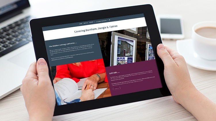 A person holding a tablet viewing the responsive Maldon Lettings website