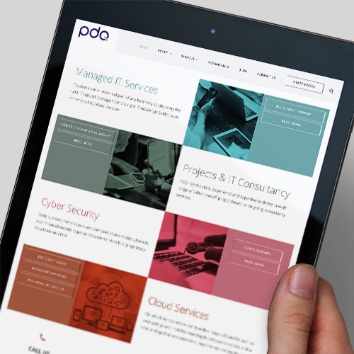 A person holding a tablet viewing the new responsive website design for PDQ Thumbnail