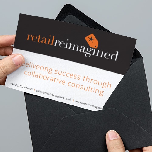 A person pulling out the Retail Reimagined postcard print design