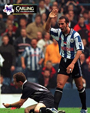 Paolo di Canio raising his hand looking at the football referee on the ground