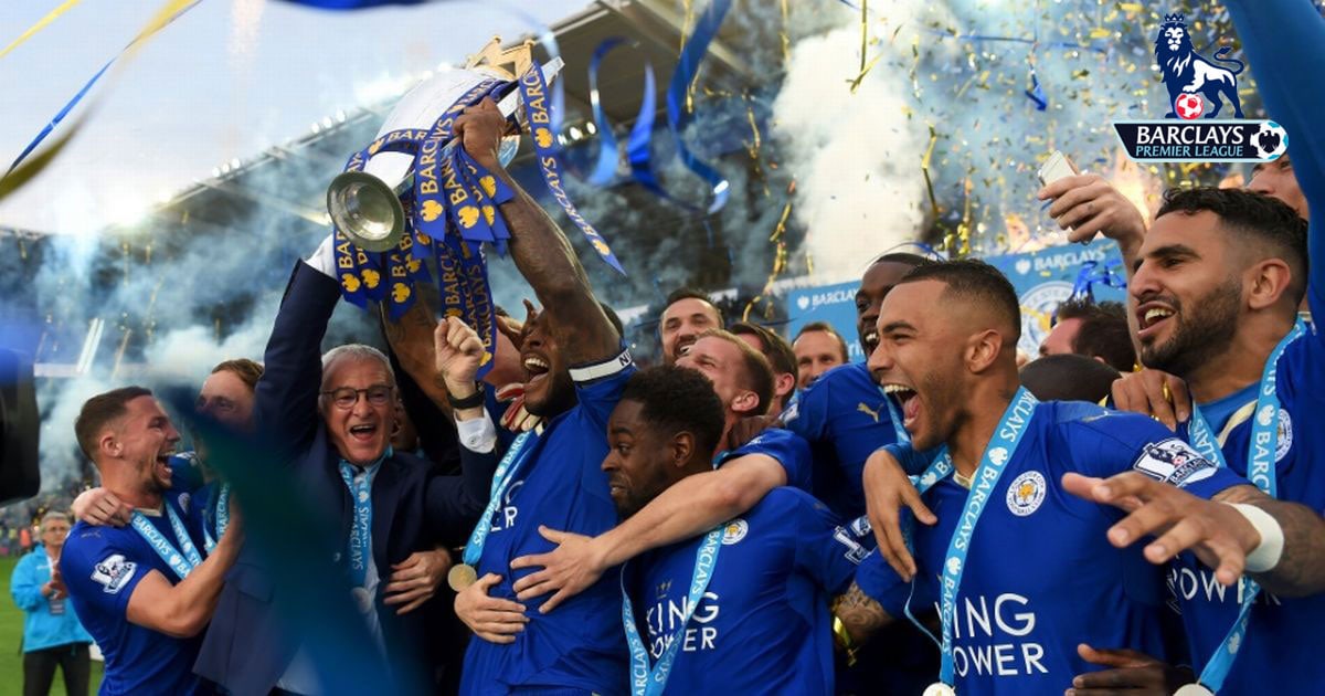 Leicester City team holding a trophy celebrating them winning the 2016 Premier League